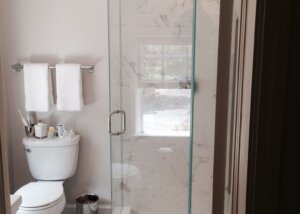 Glass door corner shower in remodeled bathroom