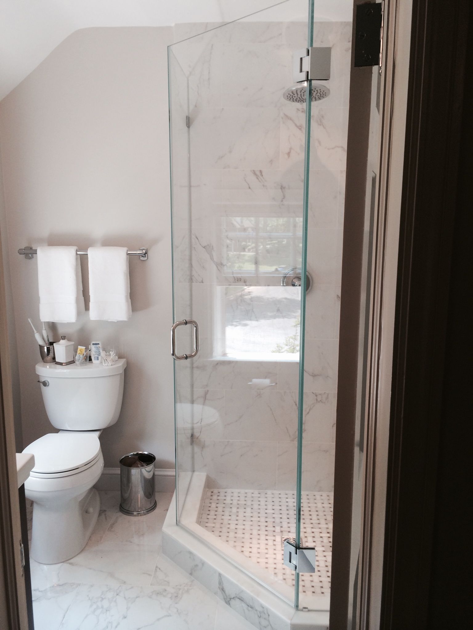 Glass door corner shower in remodeled bathroom