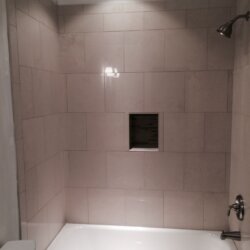 White tile bath/shower combo in finished basement bathroom