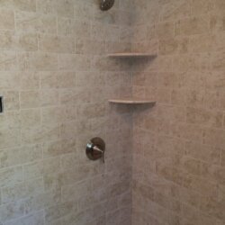 Built-in shelves in shower in remodeled bathroom