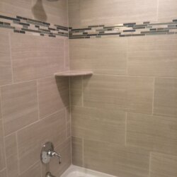 Close-up of matchstick tile accent shower in Ashburn, VA bathroom