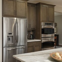 Remodeled kitchen featuring stainless steel refrigerator and double stacked oven