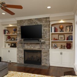 FlatscreenTV mounted above stone fireplace