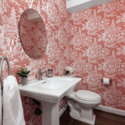 Bathroom with distinctive pink and white patterned wallpaper