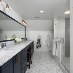 Master bathroom with white marble sinks and gray tiles