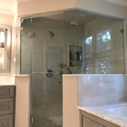 Glass walled corner shower in master bathroom