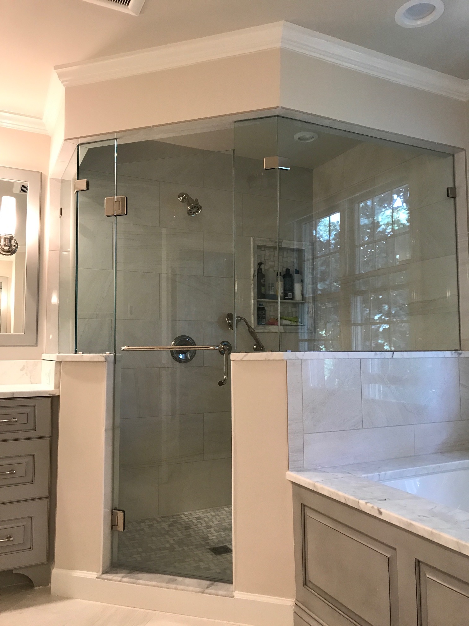 Glass walled corner shower in master bathroom