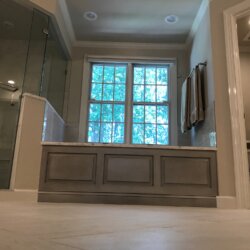 Gray master bathroom tub and corner shower