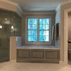 Gray master bathroom tub and corner shower