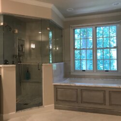 Gray master bathroom tub and corner shower