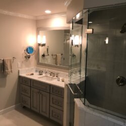 Glass walled corner shower in master bathroom