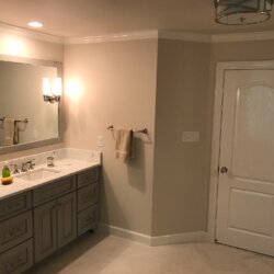 Sinks and door in remodeled master bathroom