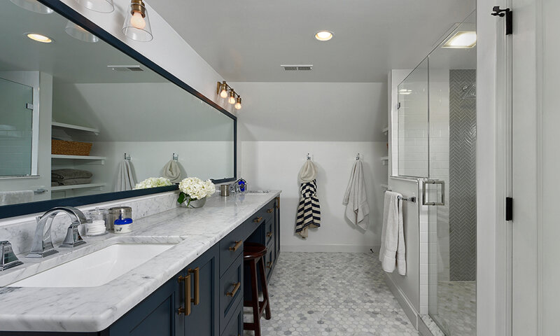Large bathroom with 2 sinks and glass shower stall